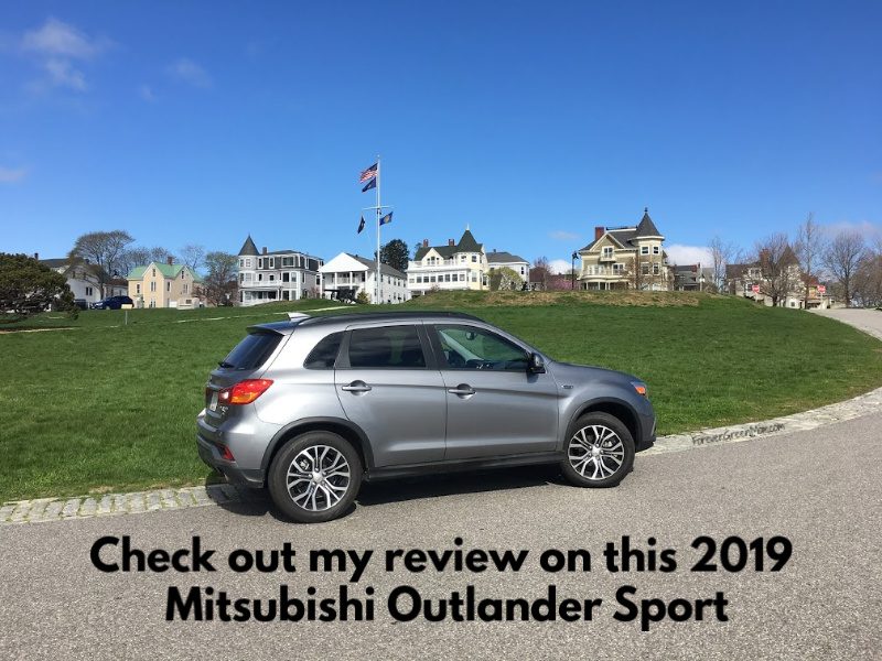 Mitsubishi Outlander with houses in the background