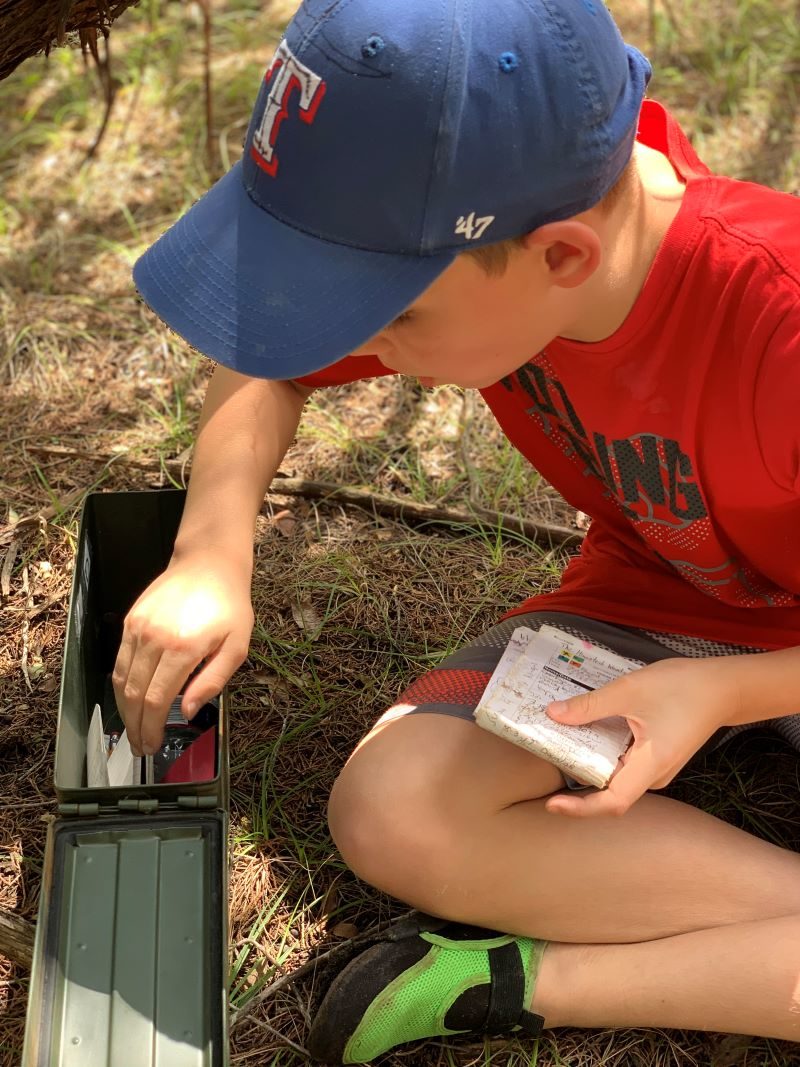 looking inside a geocache container